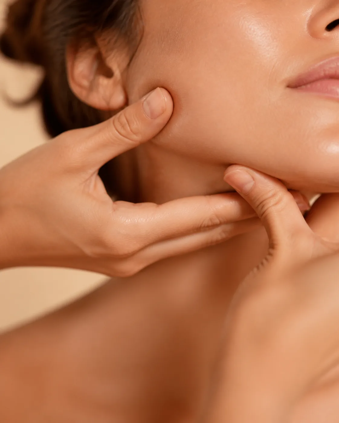 Gentle lymphatic drainage massage along the jawline